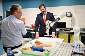 Centre Director Peter Corke demonstrating the Franka-Emika Panda arm to Hon Ed Husic MP